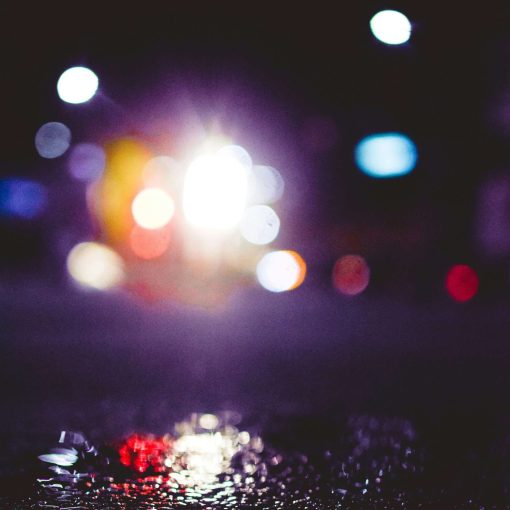 Headlight dazzle and road safety: How to adjust your lights and drive safely at night - image of bright lights reflected on wet tarmac