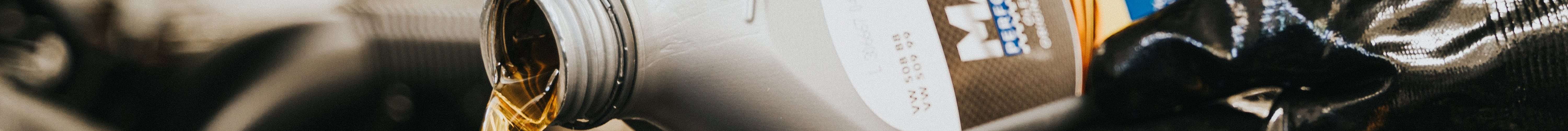 Engine oil being poured into a car engine