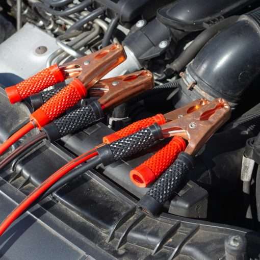 How to extend the life of your car battery - image of jump leads on an engine